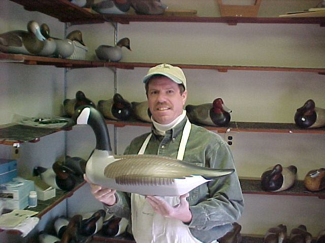Joey Jobes in his shop in Havre de Grace, MD holding a Canada Goose decoy